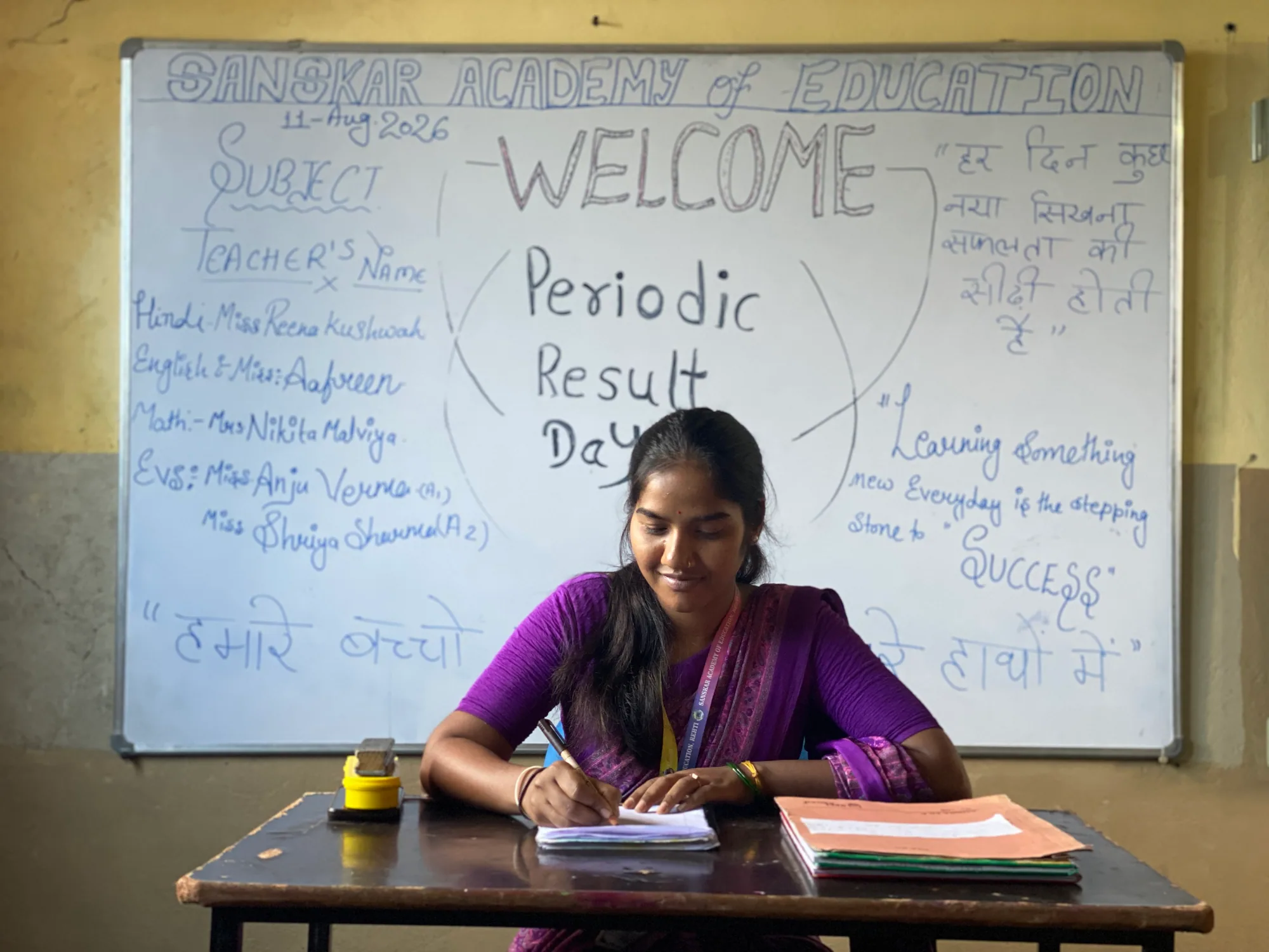 A Sanskar Academy teacher preparing student progress records